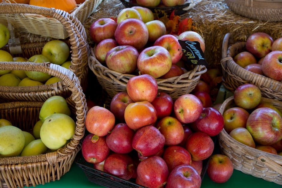 Close-up of vibrant apples in wicker baskets at a local market in fall.