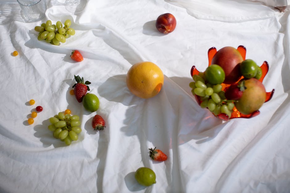 A vibrant assortment of fruits on a white cloth, capturing the essence of freshness and healthy eating.
