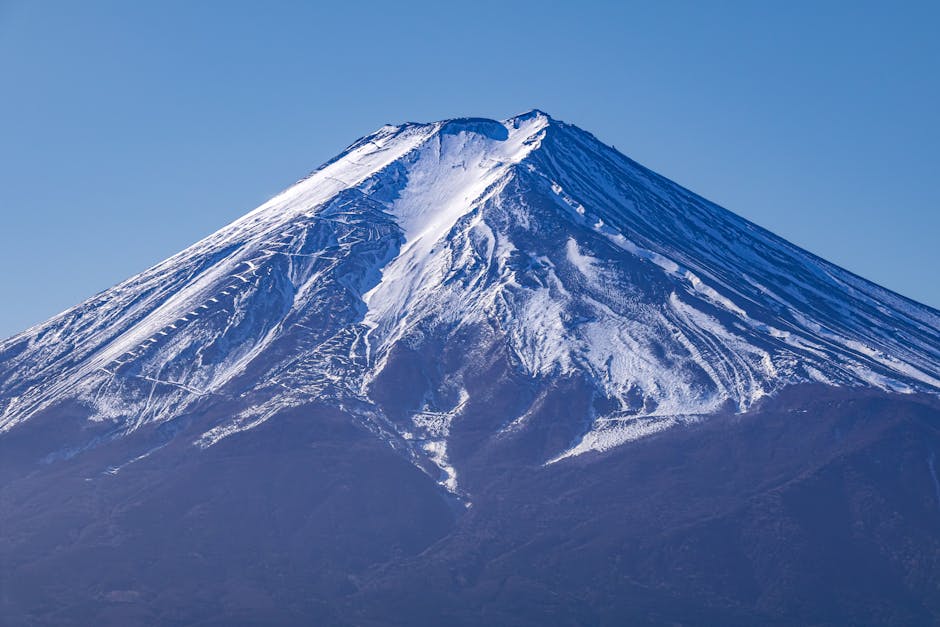 Stunning view of Mount Fuji with snow, captured on a clear day in Fujiyoshida, Japan.