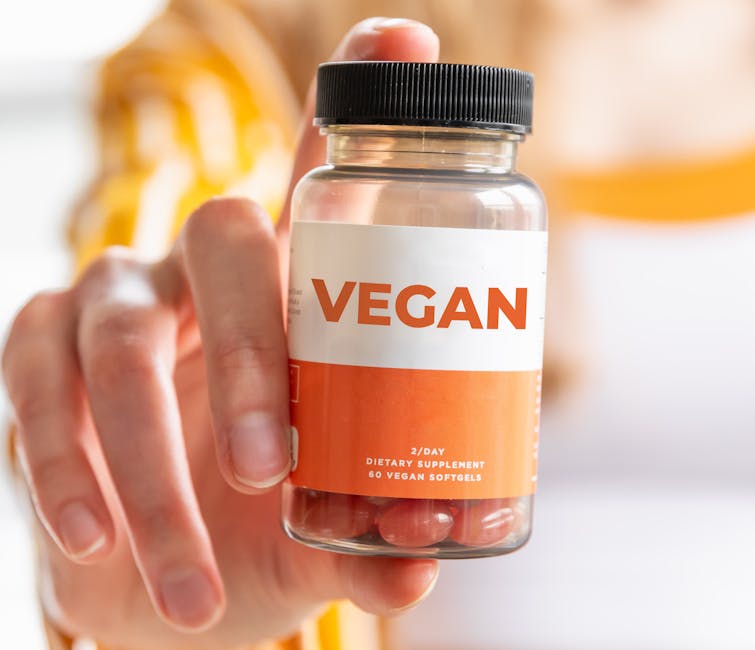 A detailed image of a hand holding a vegan supplement bottle, ideal for health and lifestyle themes.