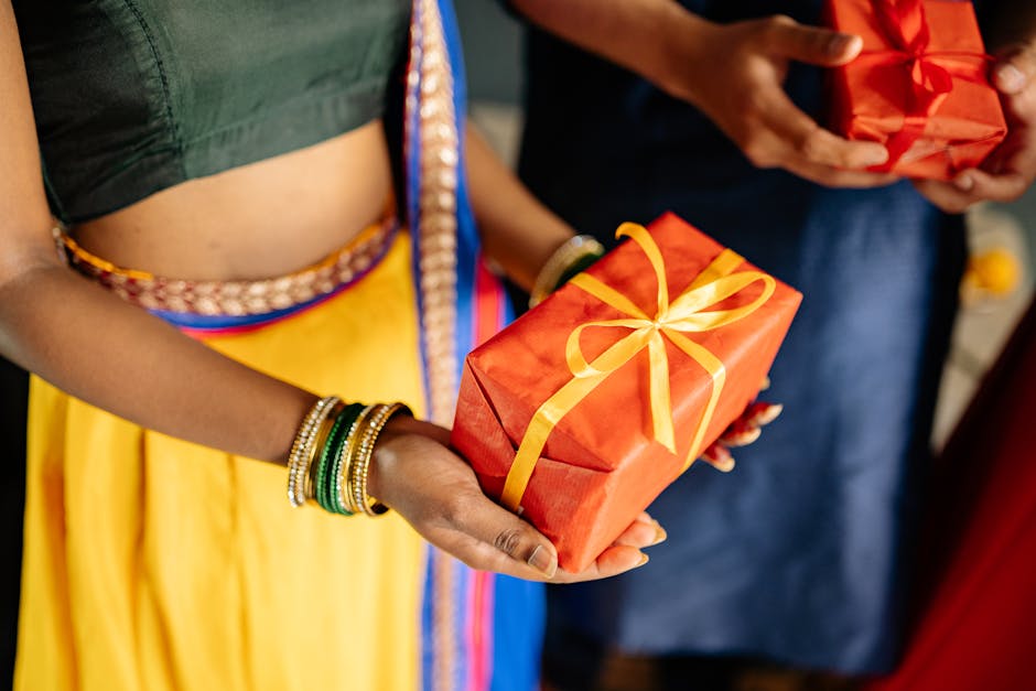 Close-up of people exchanging gifts in vibrant traditional Indian attire, ideal for festive occasions.