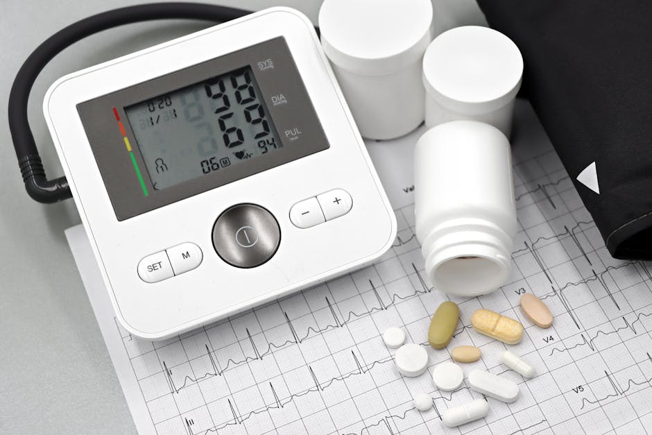 Blood pressure monitor with pills on ECG sheet, essential for heart health management.
