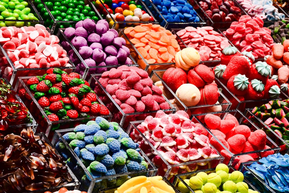 Colorful candy assortment on display at a market stall in Barcelona, Spain.