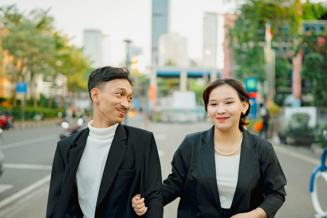 A man and a woman walking down a street