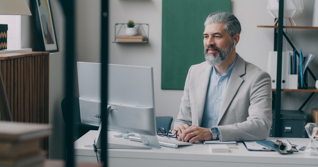 A man sitting at a desk with a laptop